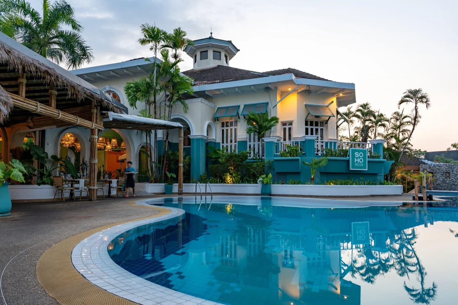 Golden-hour view across the pool at SOHO Pool Club, Boat Lagoon Marina