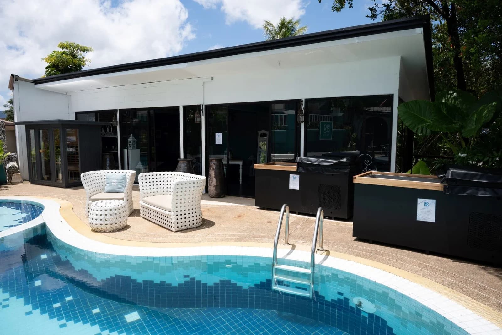 Soho Wellness Phuket – poolside view with modern white seating, ice bath stations, and relaxation area beside Soho Pool Club at Boat Lagoon Marina.