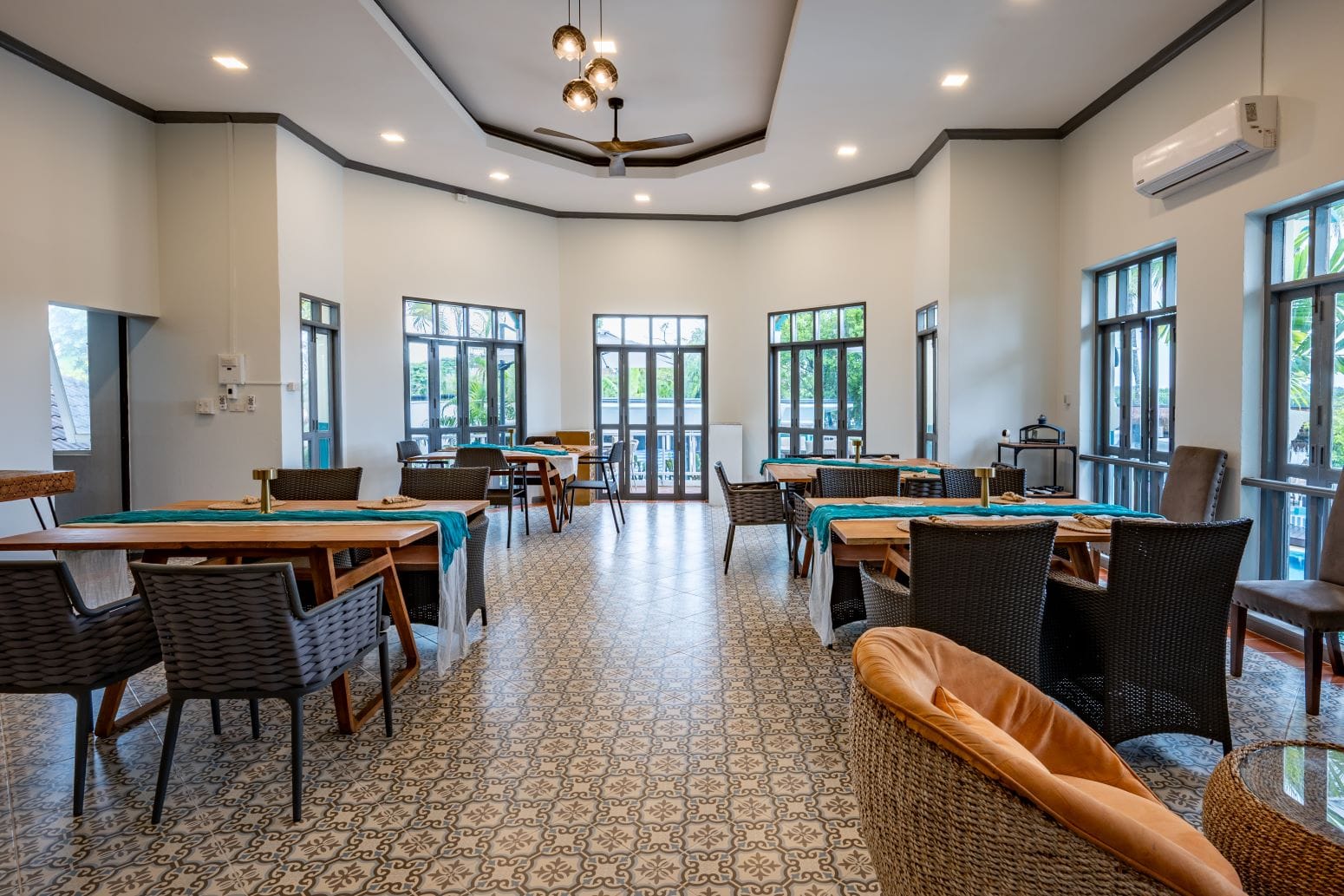 Elegant interior of SOHO Andaman Dining at Boat Lagoon Marina, featuring air-conditioned comfort, wooden tables, and Sino-Portuguese design.