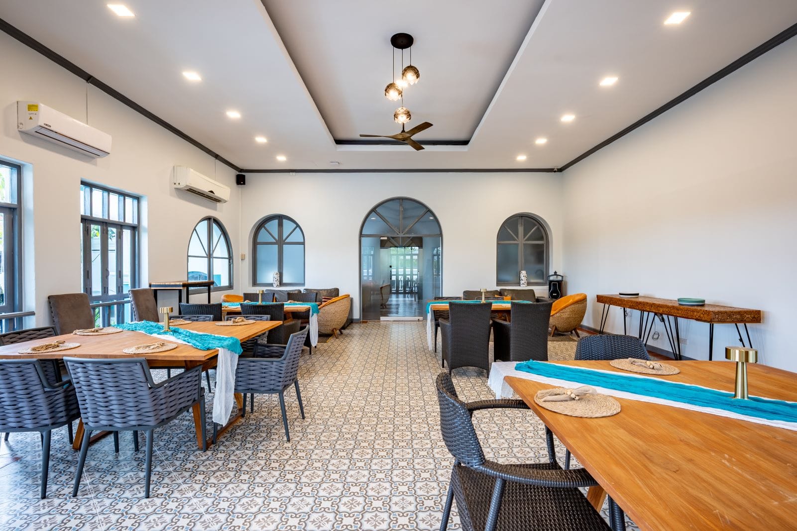 Elegant interior of Soho Andaman Dining with Sino-Portuguese design, wooden tables, and marina-inspired decor in Phuket.